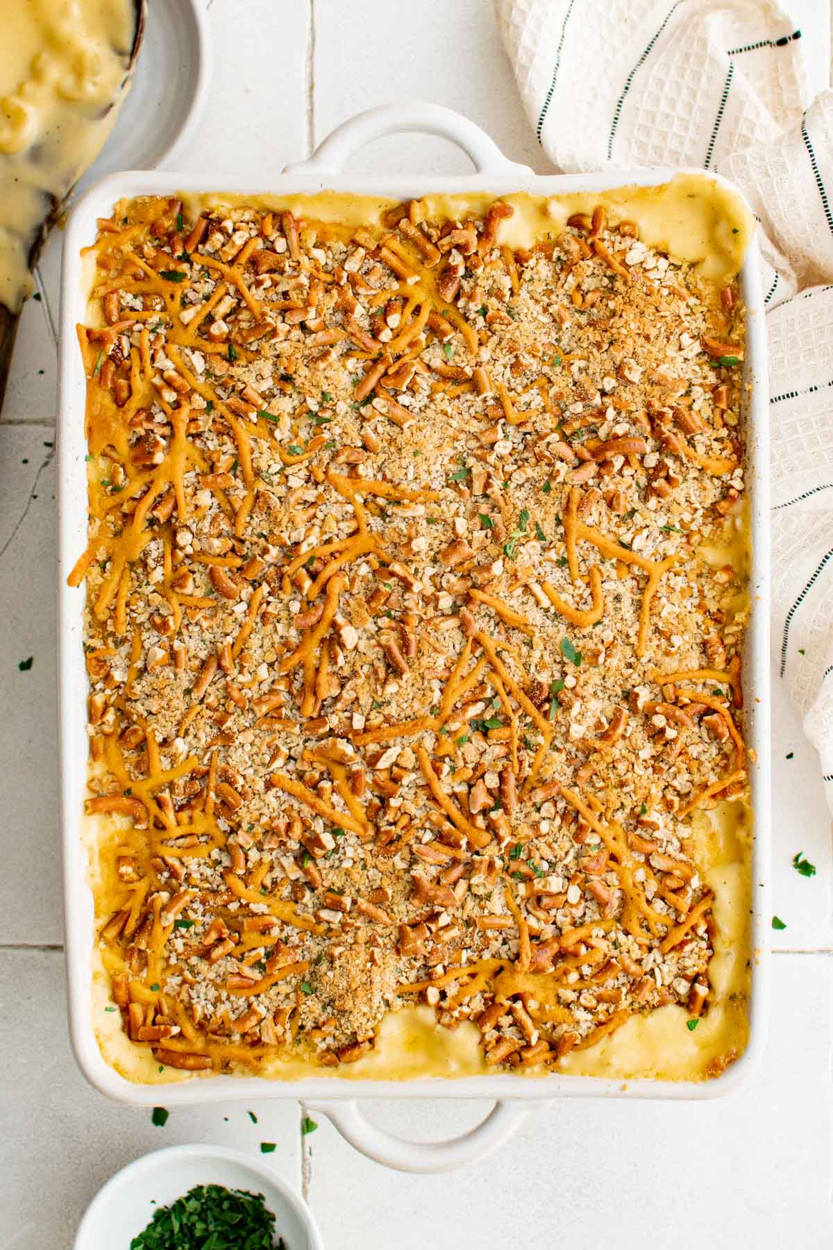 Creamy & cheesy Baked Mac and Cheese recipe with tangy cheese sauce covered pasta & a pretzel crust. This Baked Macaroni and Cheese is pure comfort food. Pan of baked mac and cheese