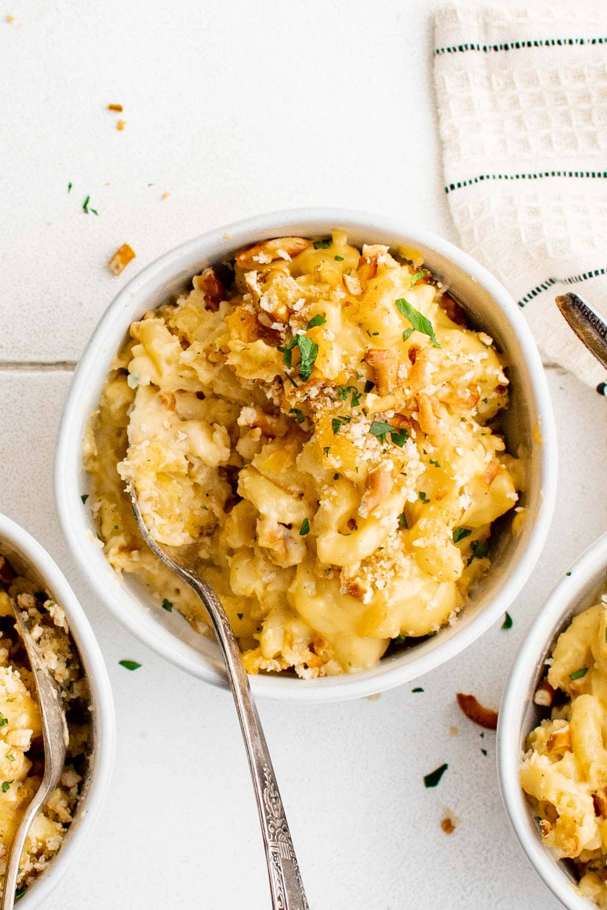 Creamy & cheesy Baked Mac and Cheese recipe with tangy cheese sauce covered pasta & a pretzel crust. This Baked Macaroni and Cheese is pure comfort food.
