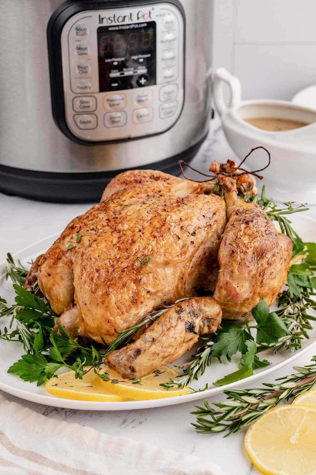 Whole chicken in front of an instant pot.