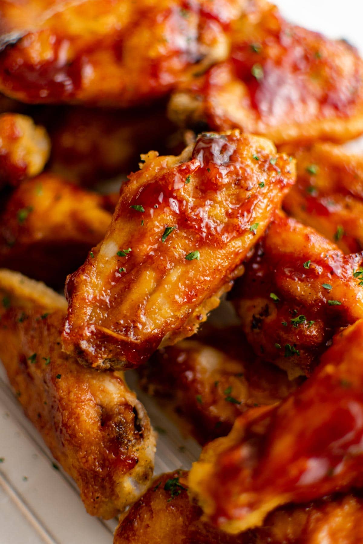 Chicken wings with bbq sauce in a pile.