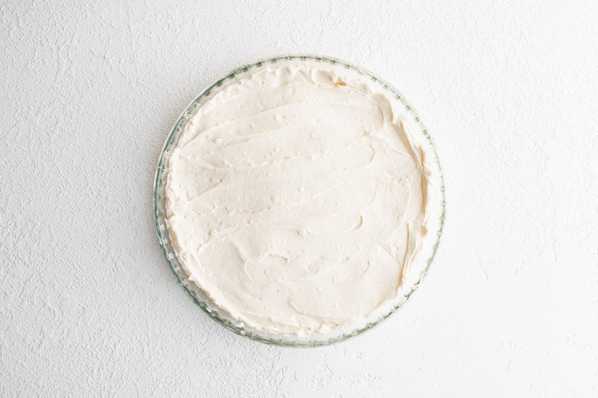 Creamy base for blt dip in a pie plate.
