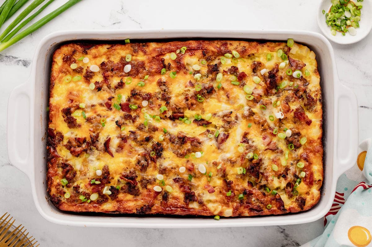 Breakfast biscuit casserole in a white baking dish.