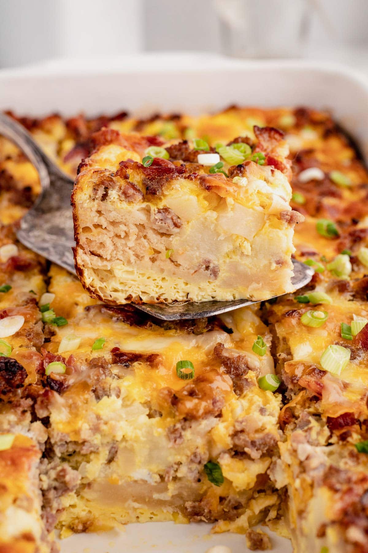 Breakfast casserole, slice on a spatula on top of the casserole.