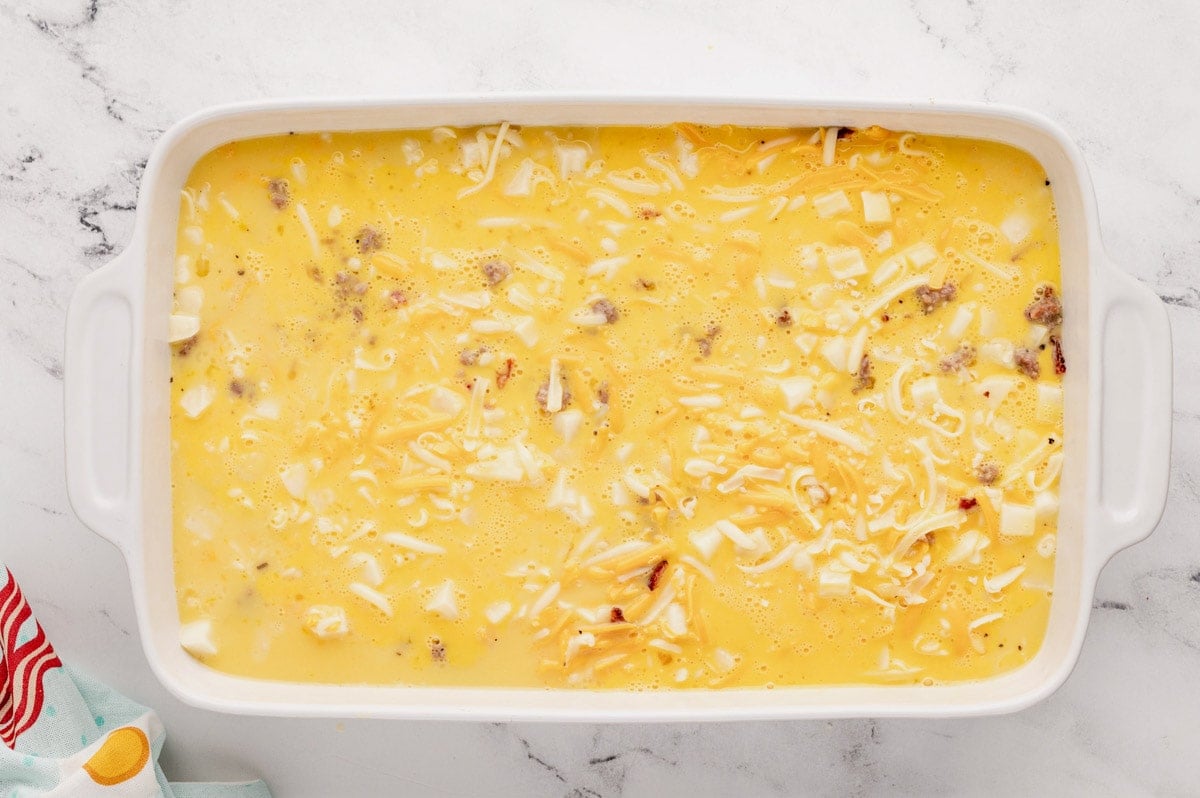 Baking dish with sausage, diced potatoes and cheese.