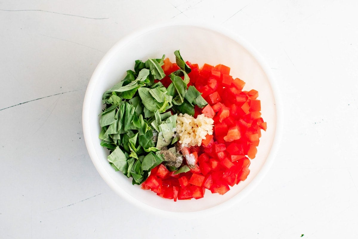 Diced tomato, basil and garlic in a bowl