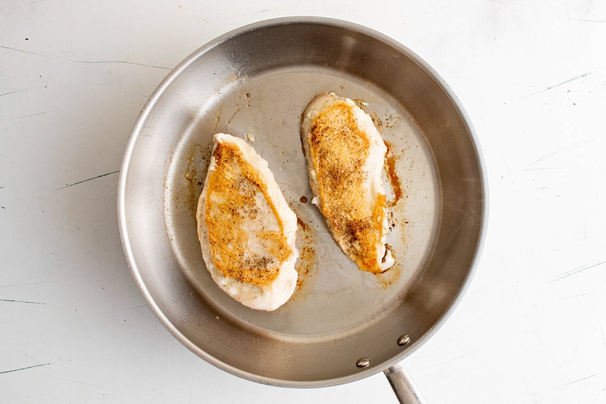 Chicken breasts in a skillet.