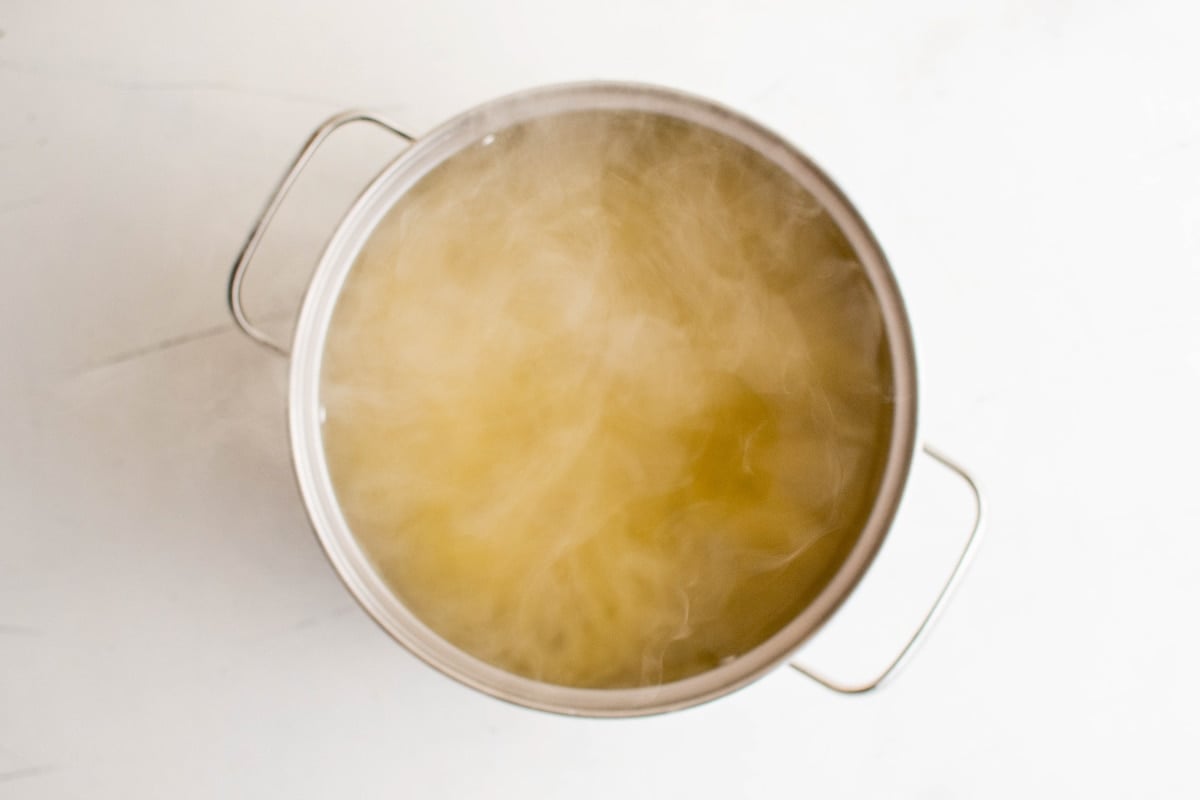 Water and angel hair pasta in a pot.