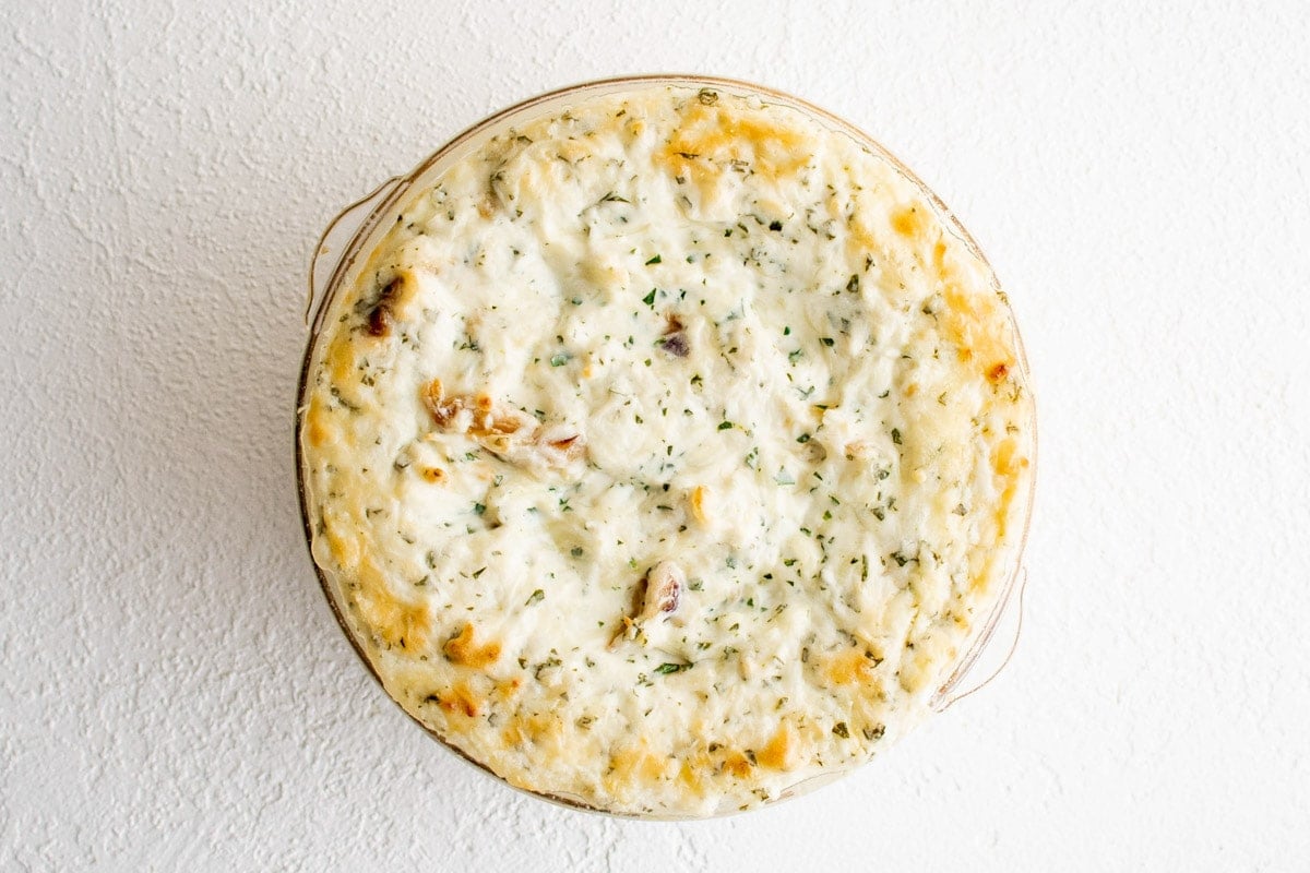 Baked Garlic Cheese Dip in a round baking dish.