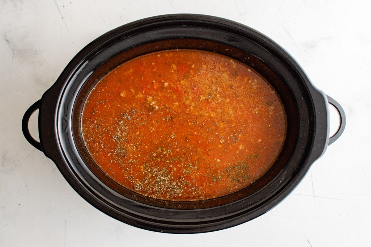 Spaghetti sauce and spices in a crockpot.