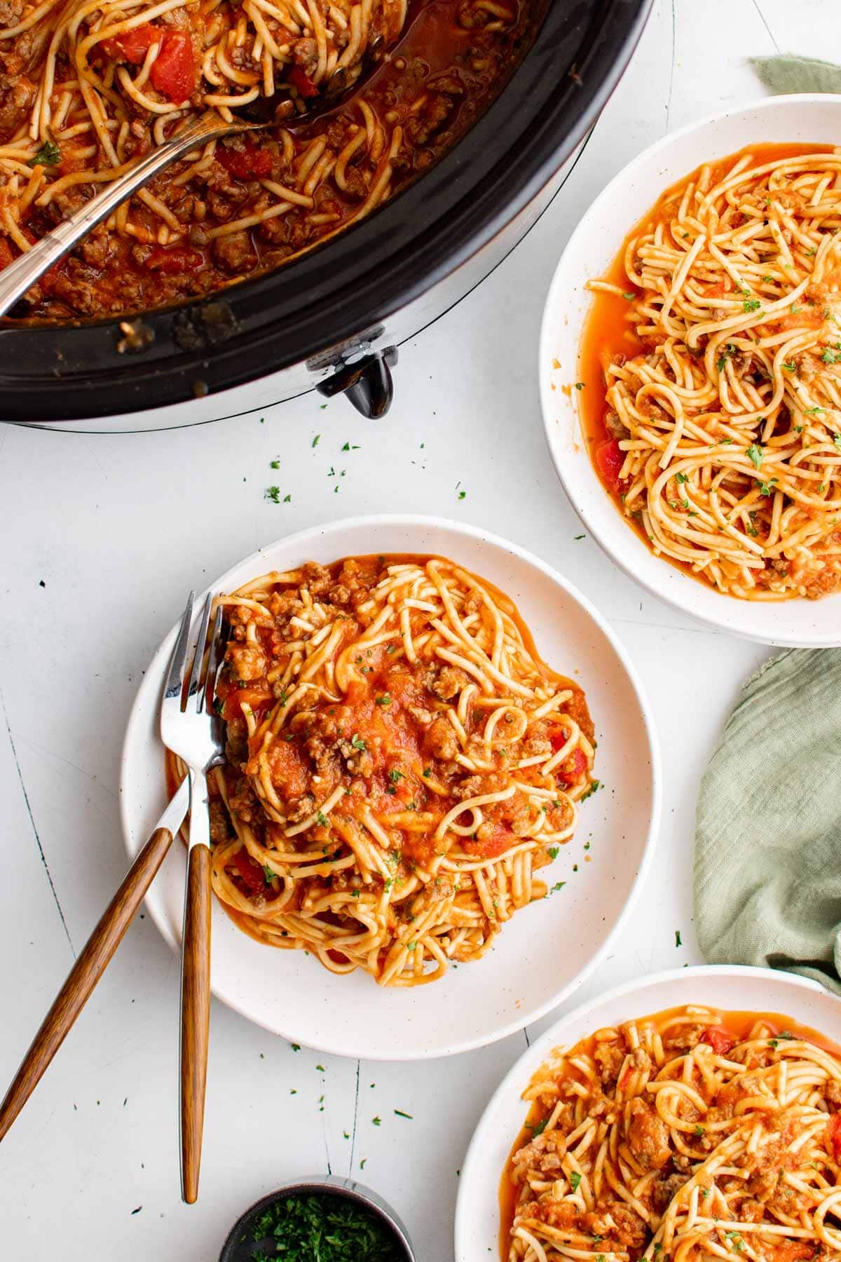 Spaghetti on plates iwth forks.