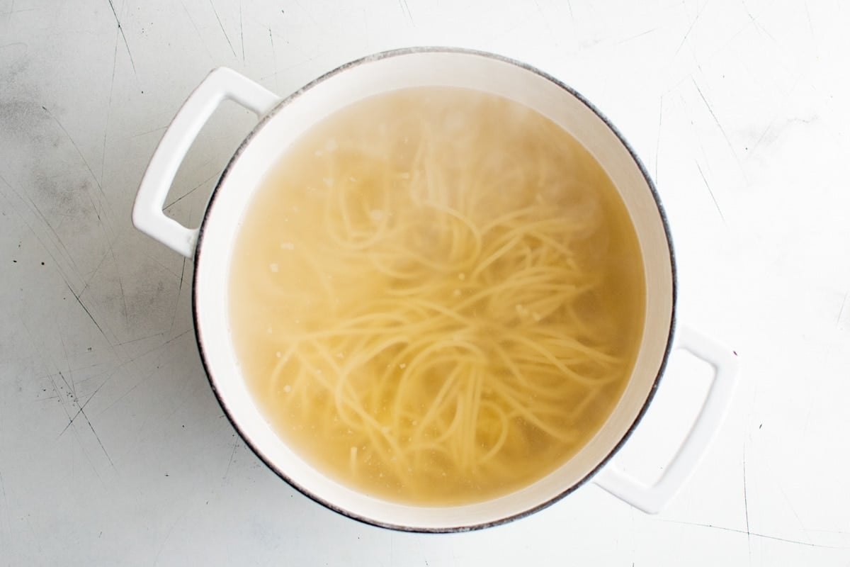 Spaghetti boiling in a large pot.