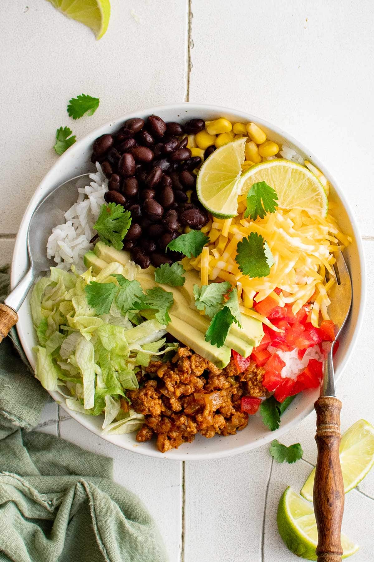 Turkey Taco bowl with rice, lettuce, tomatoes, beans, cheese and cilantro.