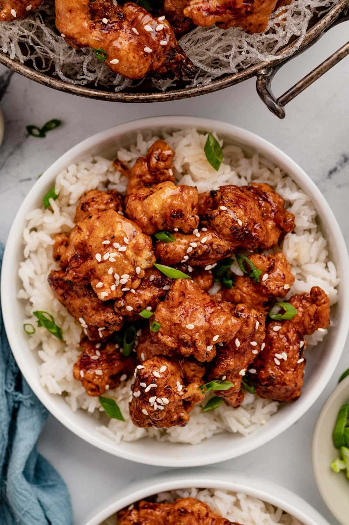 Bowl of honey chicken over rice.