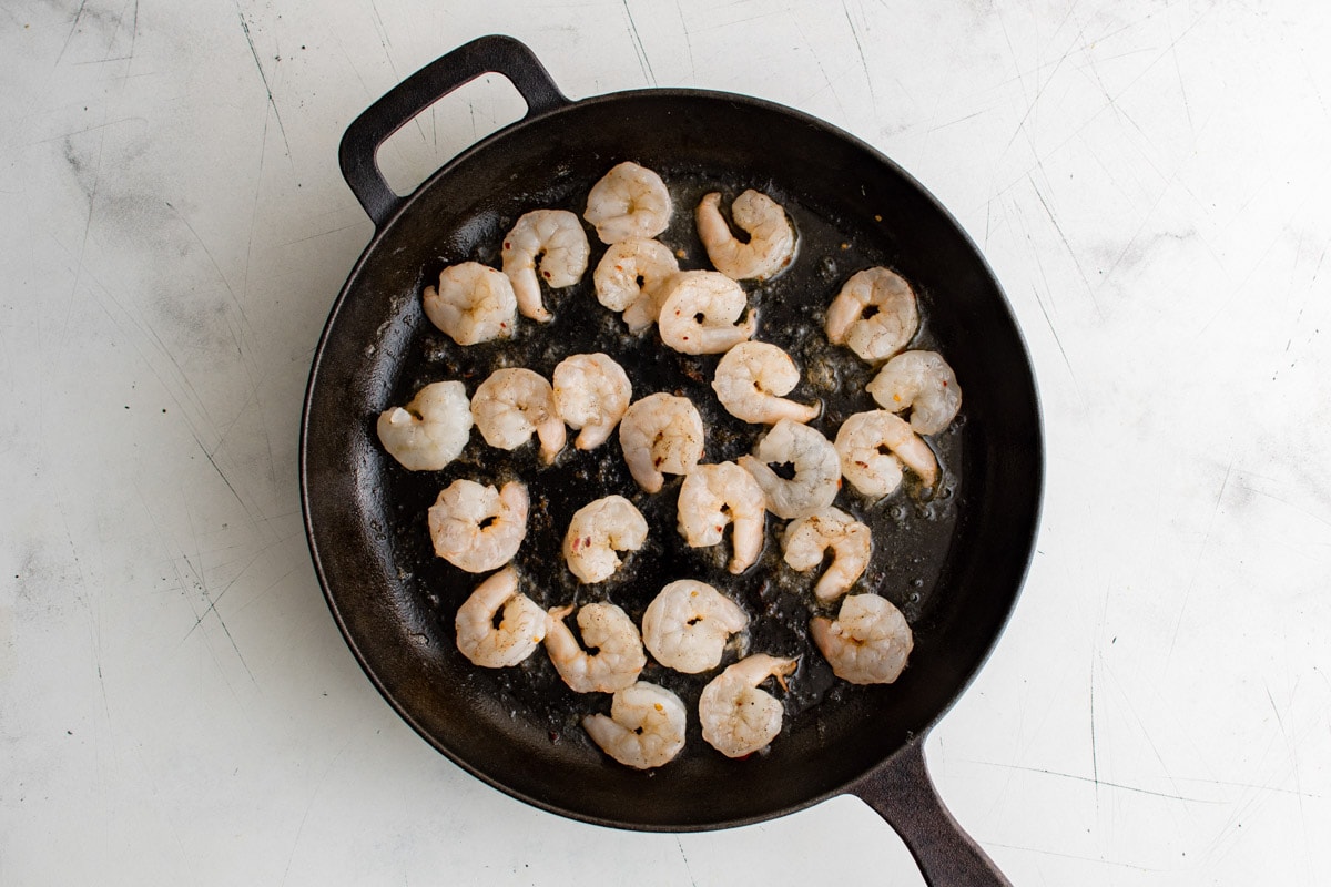 Shrimp in a black skillet.