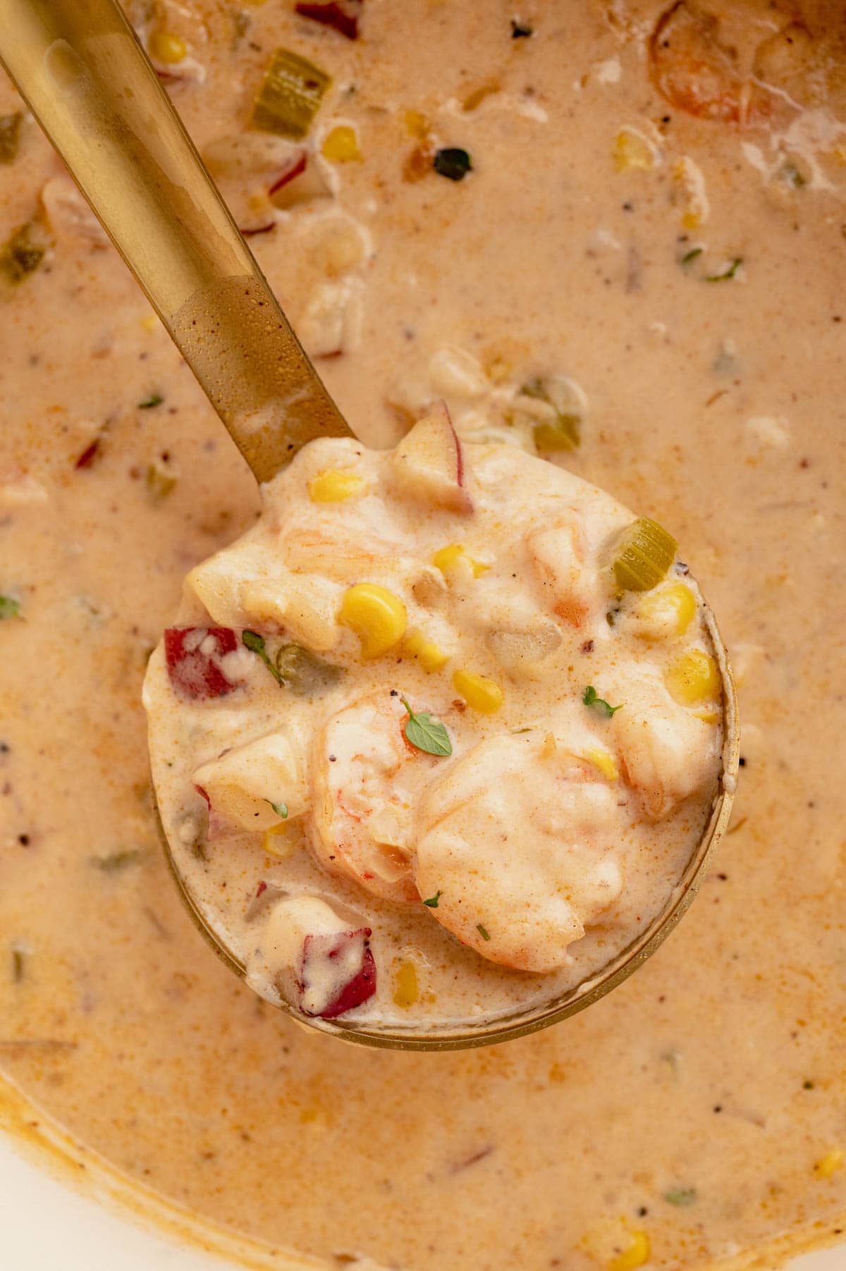 Gold ladle with shrimp soup.