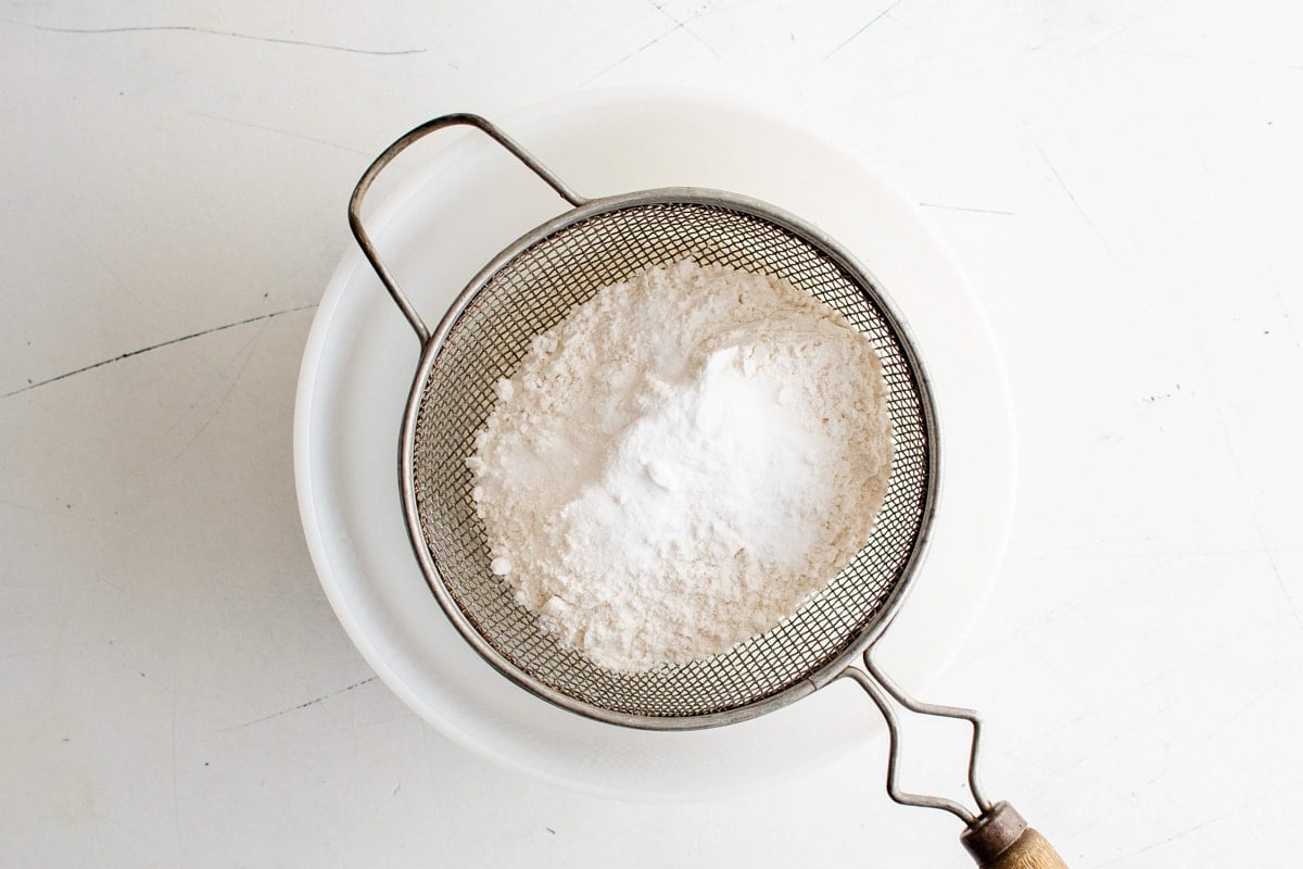 Sifter over a bowl with flour.