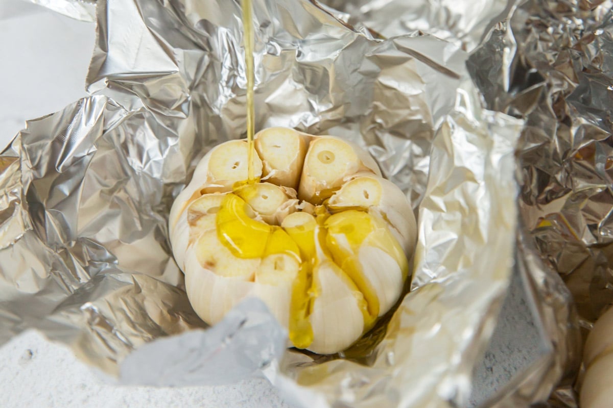 Raw head of garlic in foil with olive oil. 