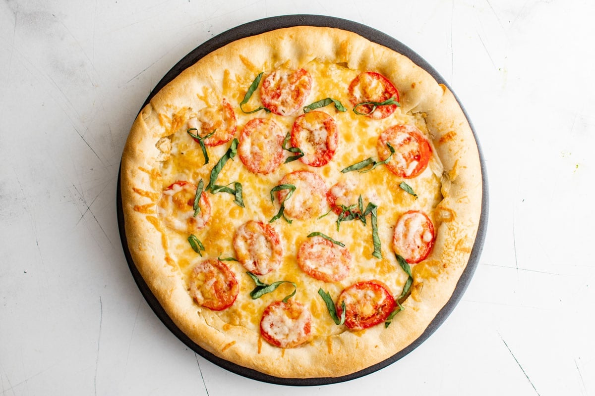 Tomato and cheese pizza with basil.