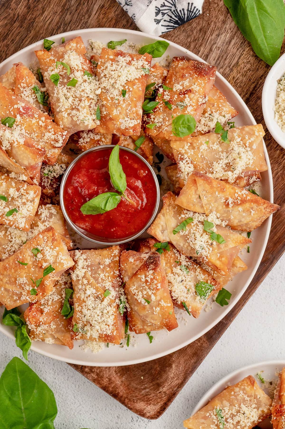 Air fryer pizza rolls on a round platter.