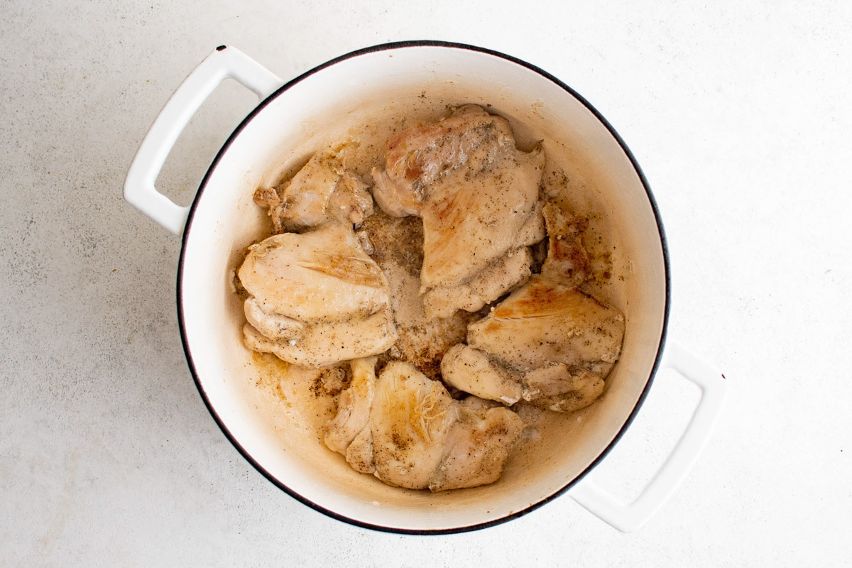 seared chicken thighs in a large dutch oven.