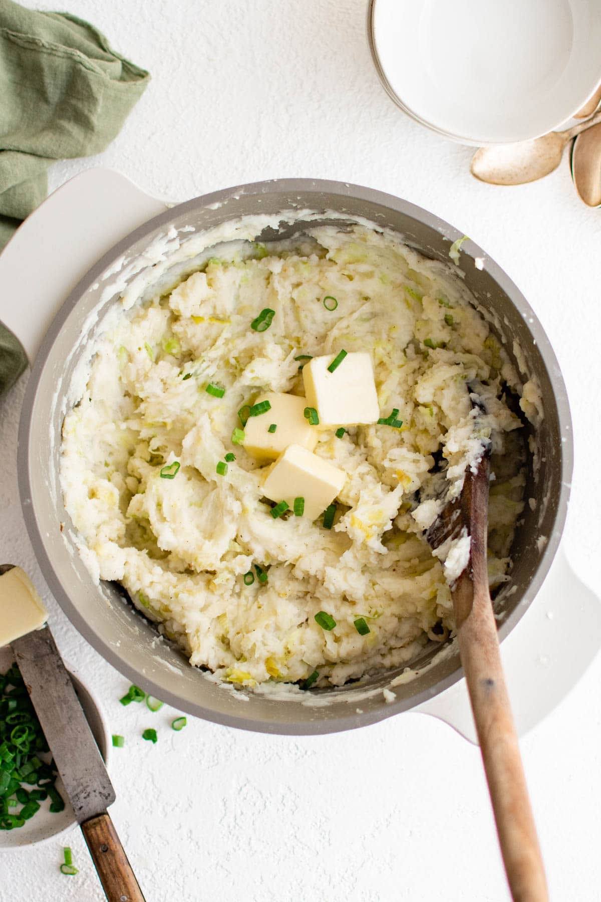 Colcannon is a traditional Irish recipe of mashed potatoes, cabbage & leeks that's perfect for celebrating St. Patrick's Day! Mashed potatoes with cabbage in a bowl with a spoon.