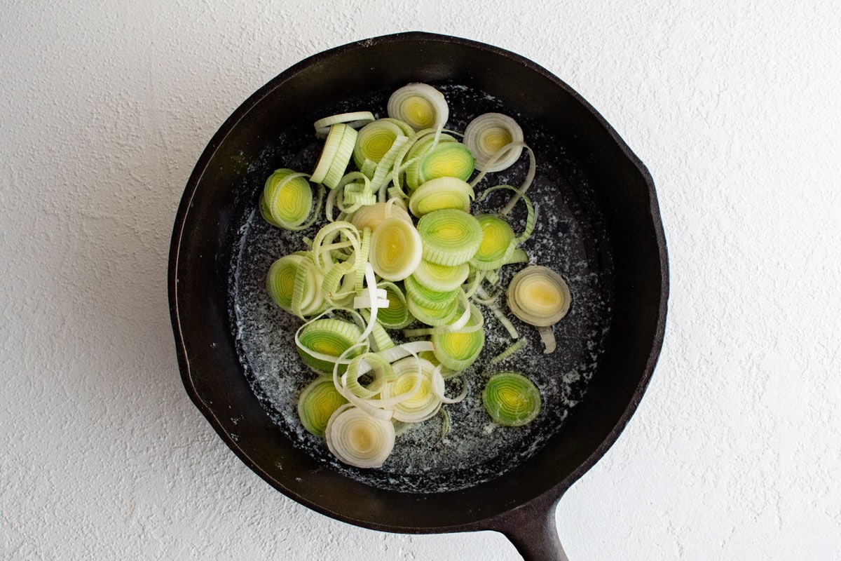 Sliced leeks in a large skillet.