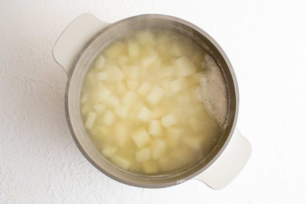 Cubes of potatoes in boiling water.