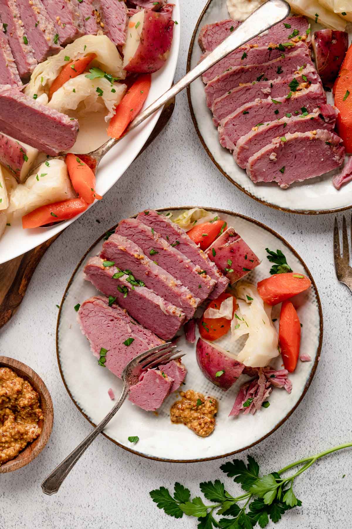 Dinner plates with corned beef slices, carrots and cabbage.