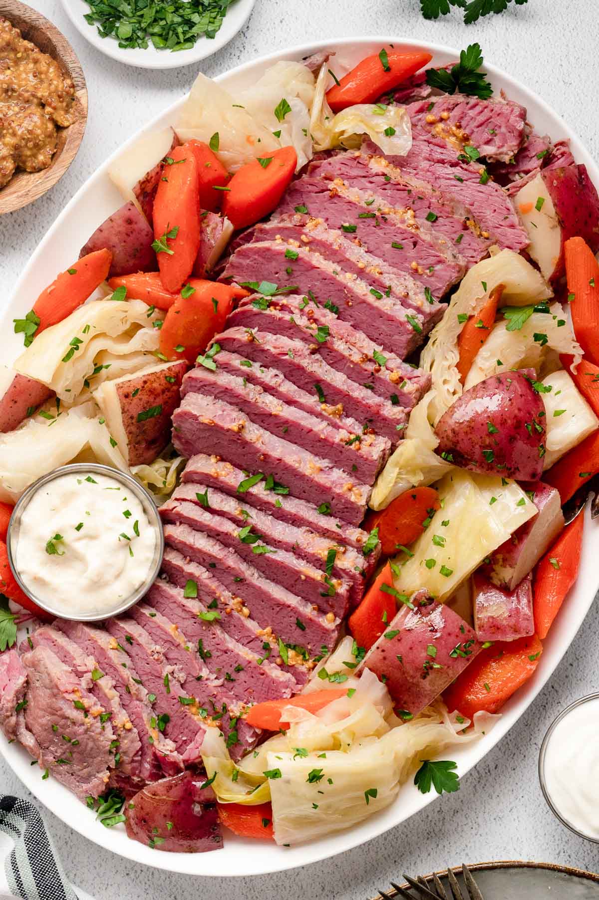 Platter with sliced corned beef, potatoes, carrots and cabbage. 