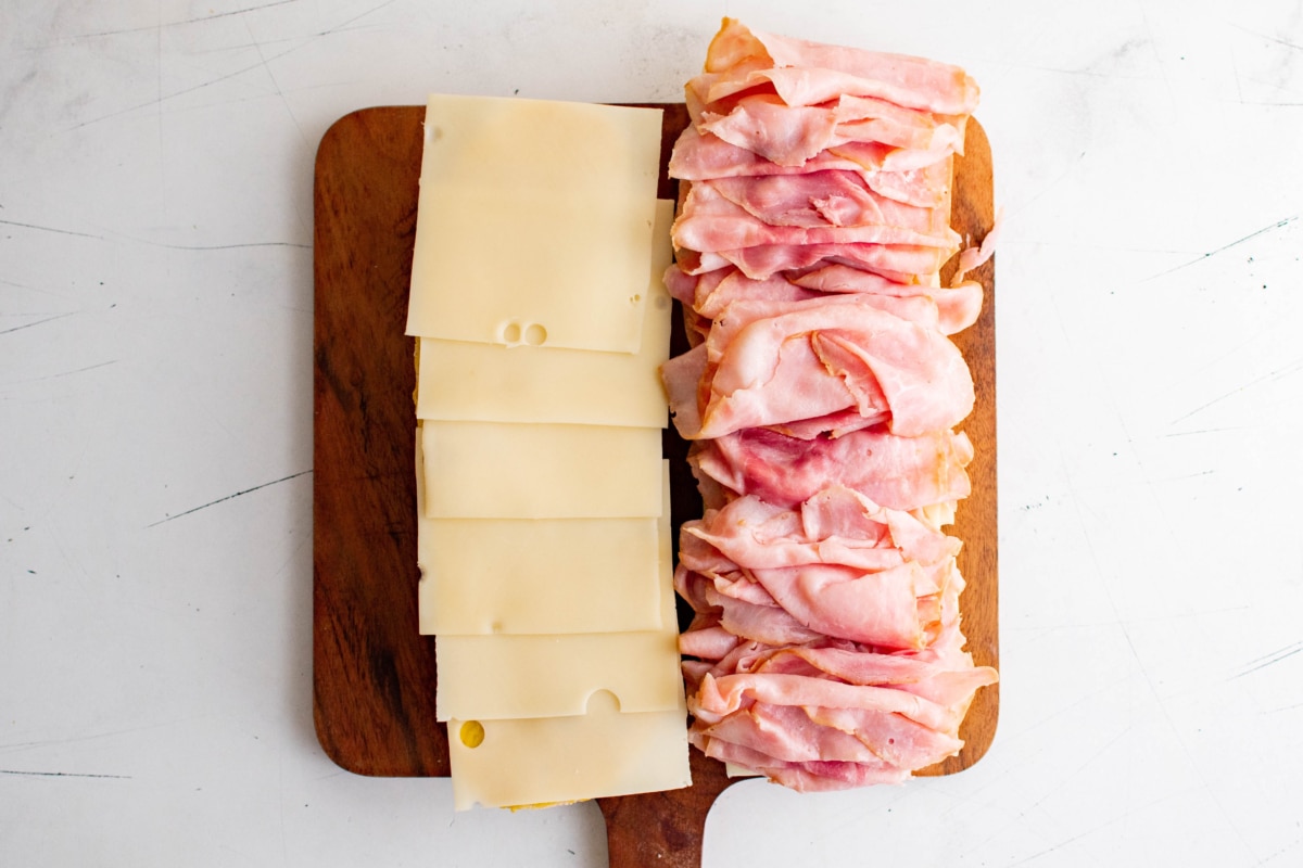 Slices of cheese and slices of ham on bread.
