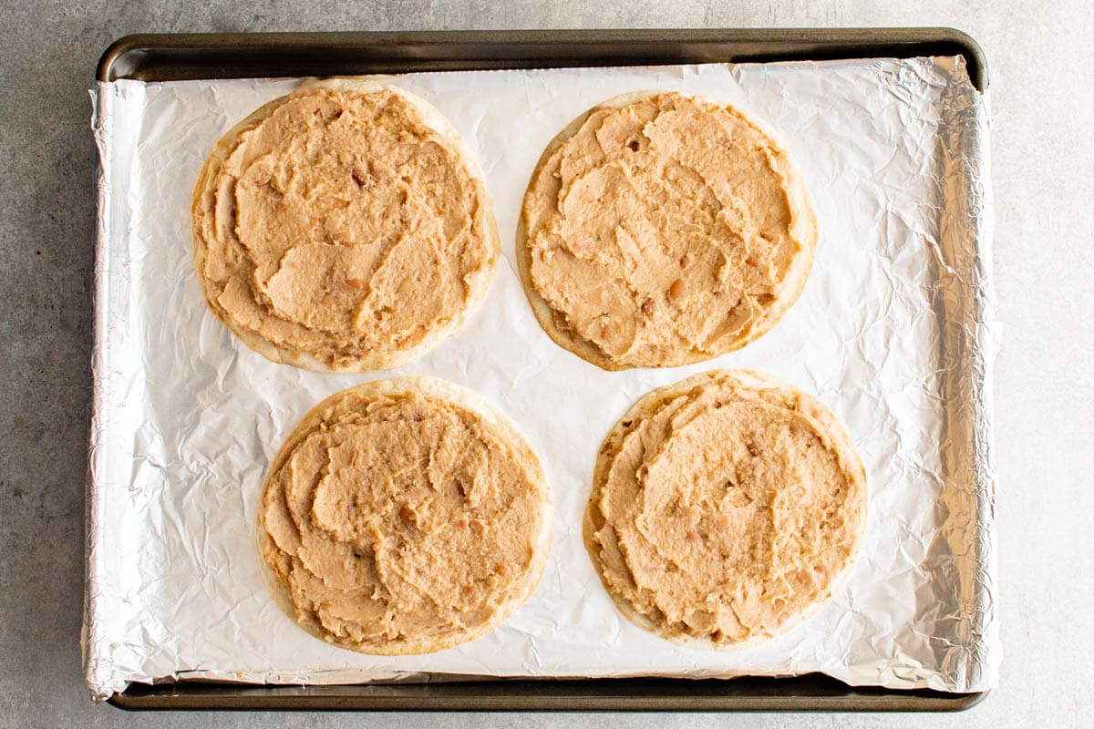 Refried beans spread onto a crispy tortilla.