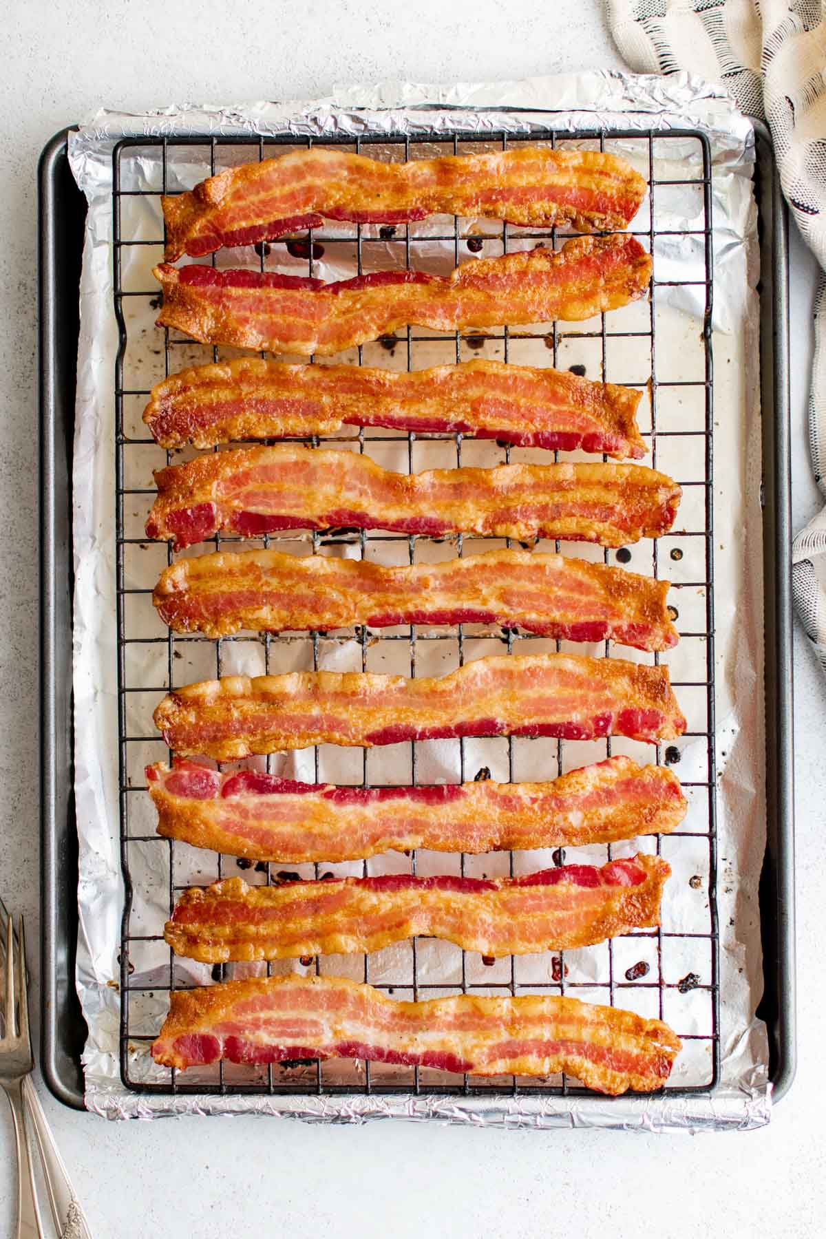 Bacon on a baking rack and baking sheet.