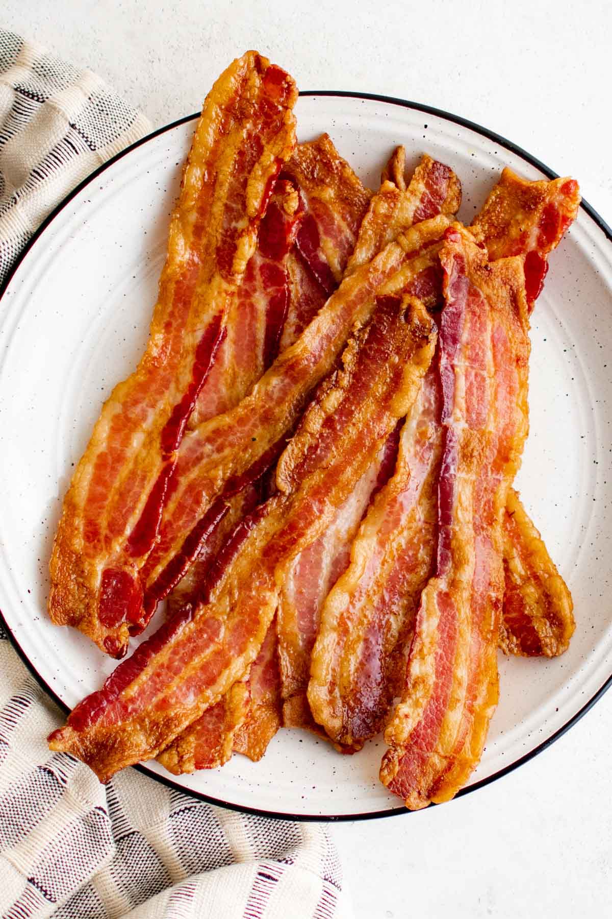 Slices of crispy bacon on a plate.