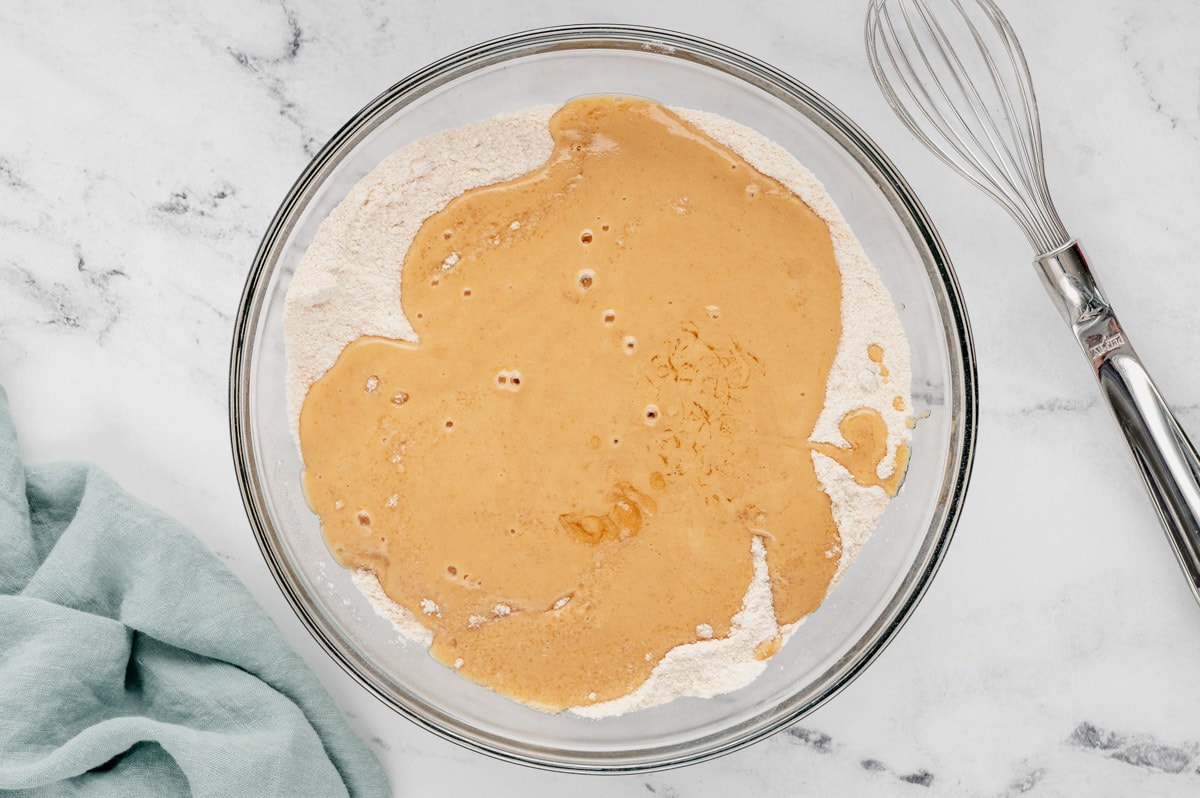 melted peanut butter and dry cake ingredients in a bowl.