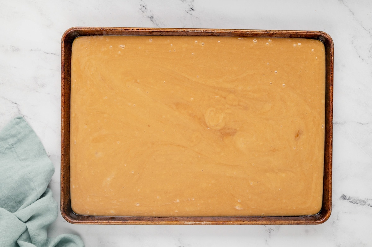 Peanut butter cake batter in a sheet pan.