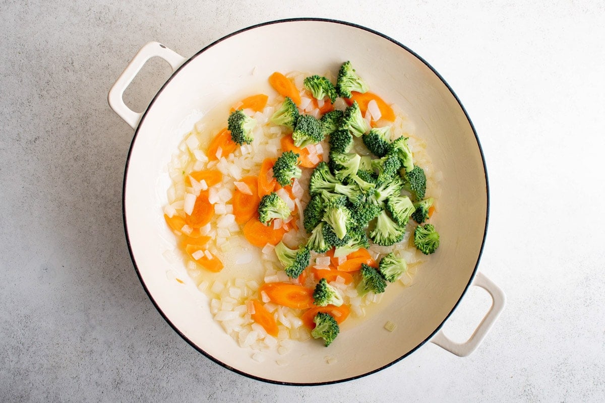 carrots, onions and broccoli in a skillet.