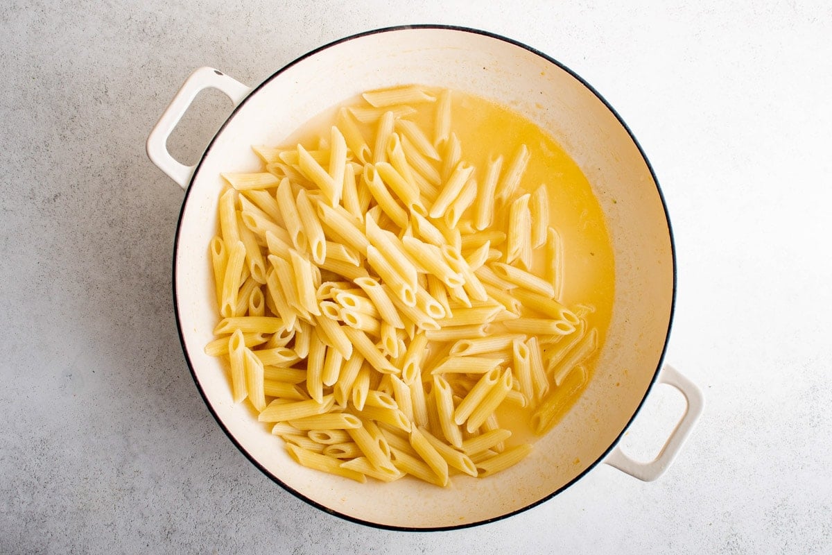 Penne pasta in a lemon butter sauce in a skillet.