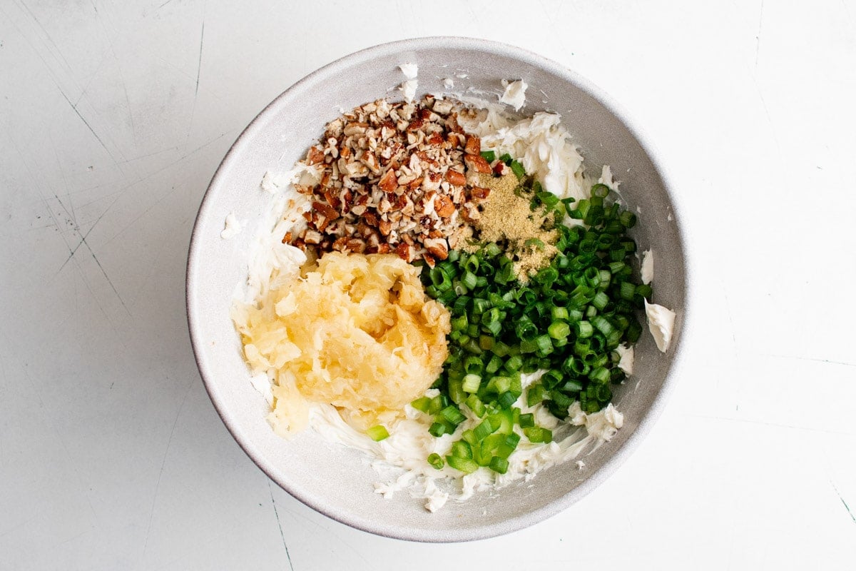 Cream cheese with sliced green onions, bell pepper, pineapple and pecans.