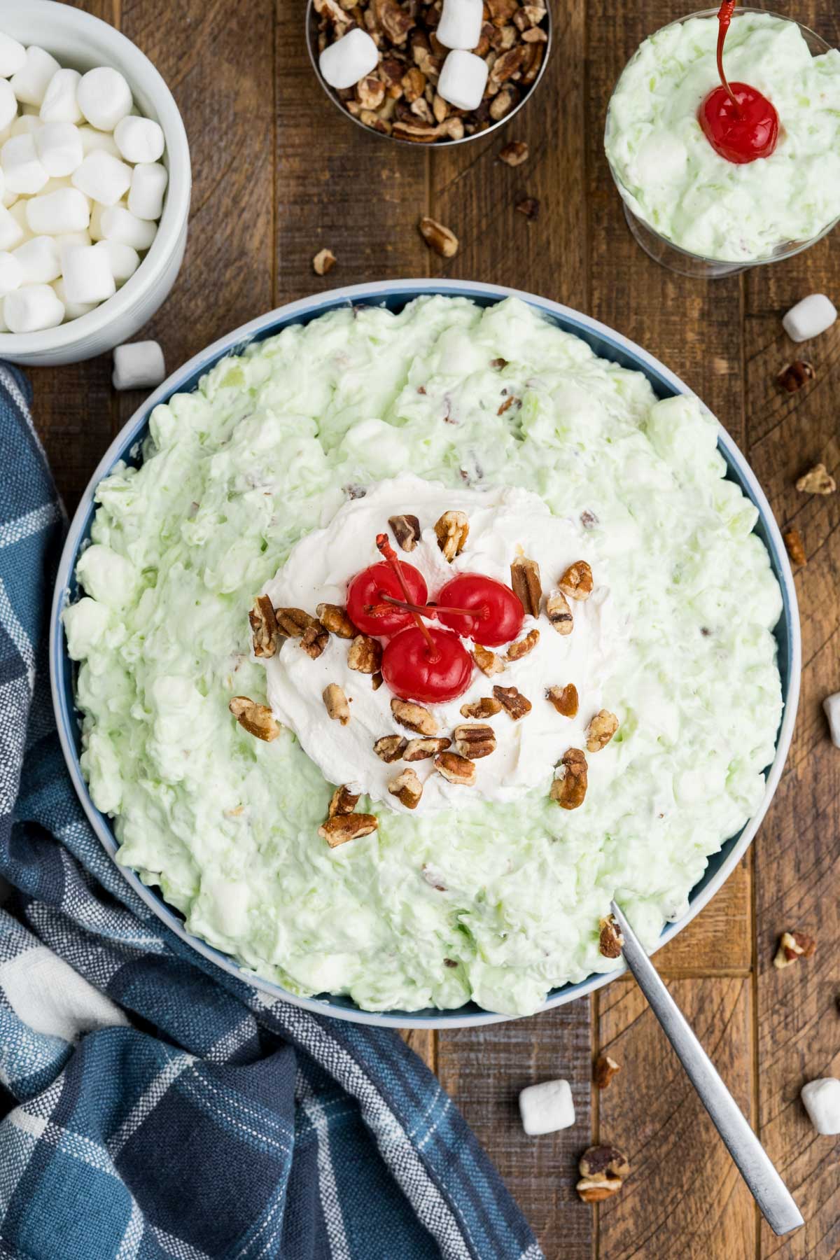 Pistachio fluff salad in a serving bowl with a spoon.