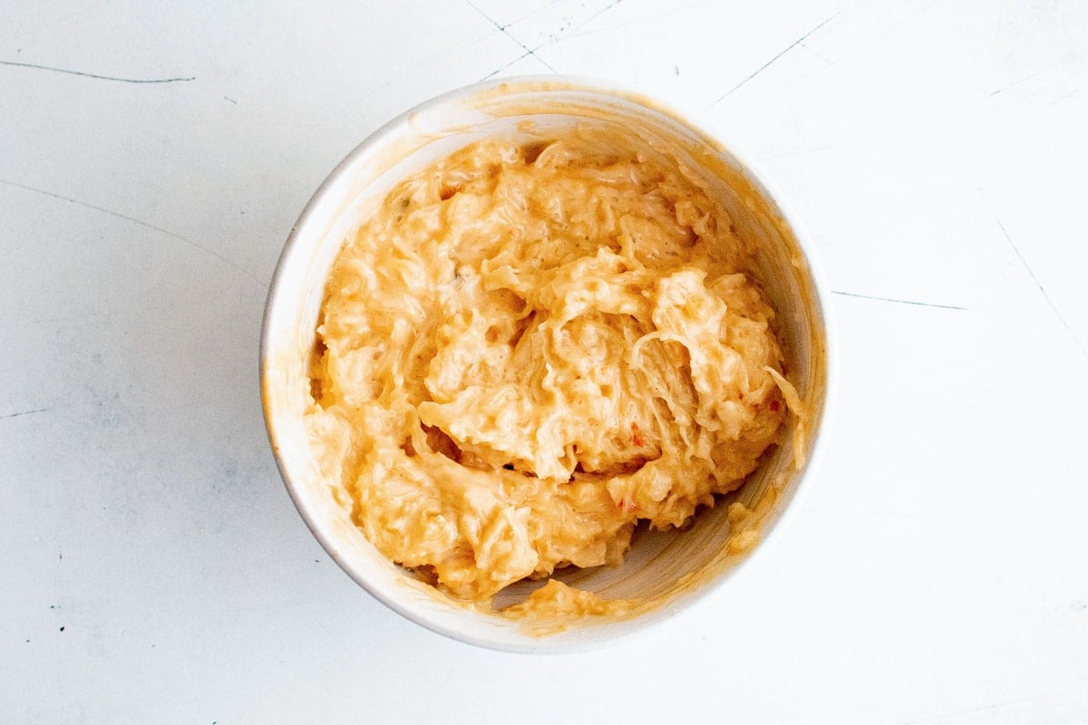 Sauerkraut and thousand island dressing in a white bowl.