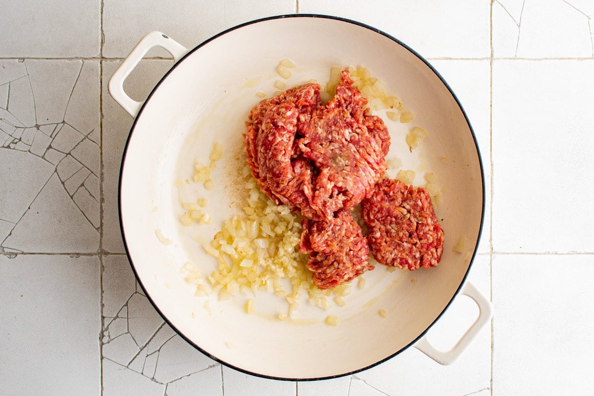 Ground sausage and onion in a large skillet.