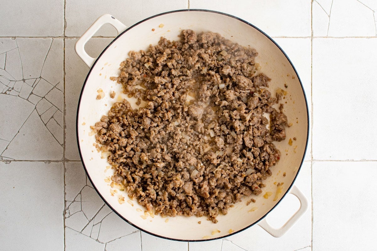 Cooked Italian sausage in a skillet.