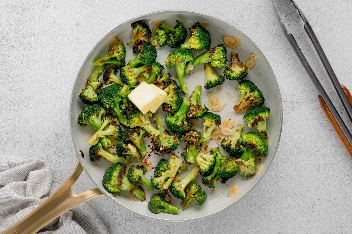 Sauteed broccoli in a skillet with butter.