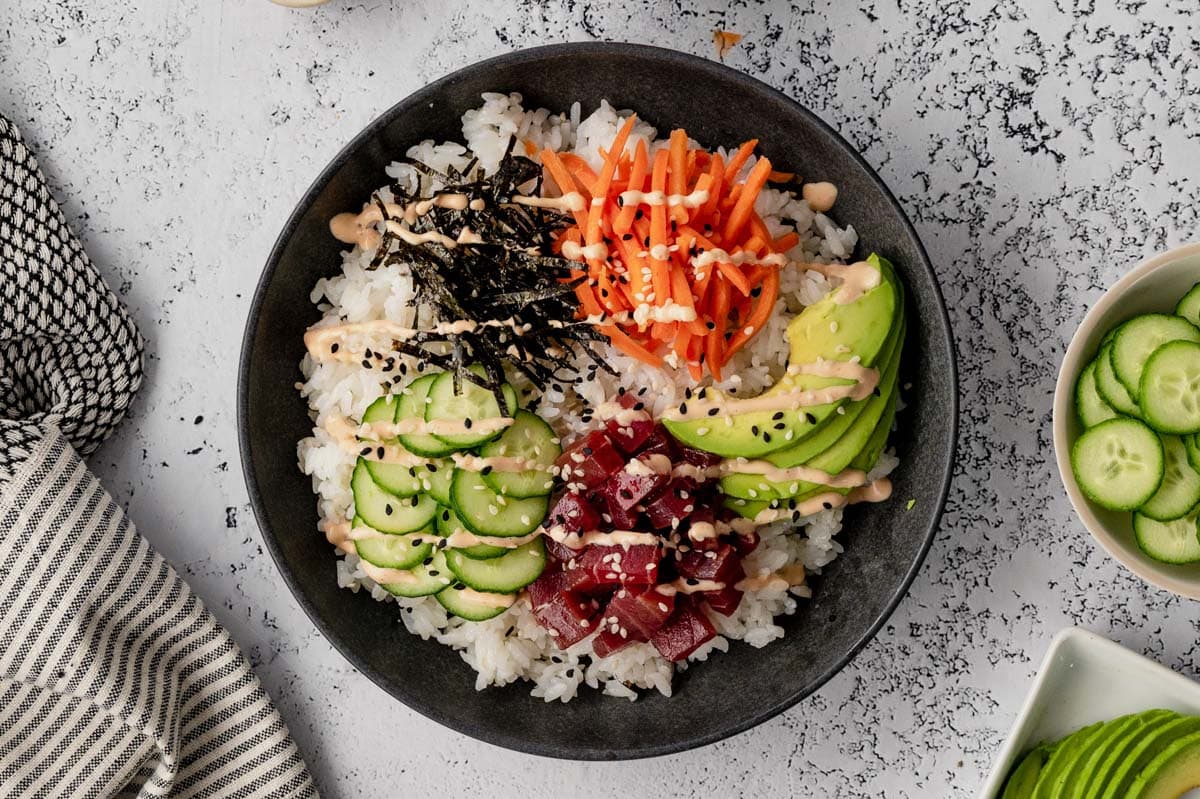 stick rice in a bowl with cucumbers and nori.