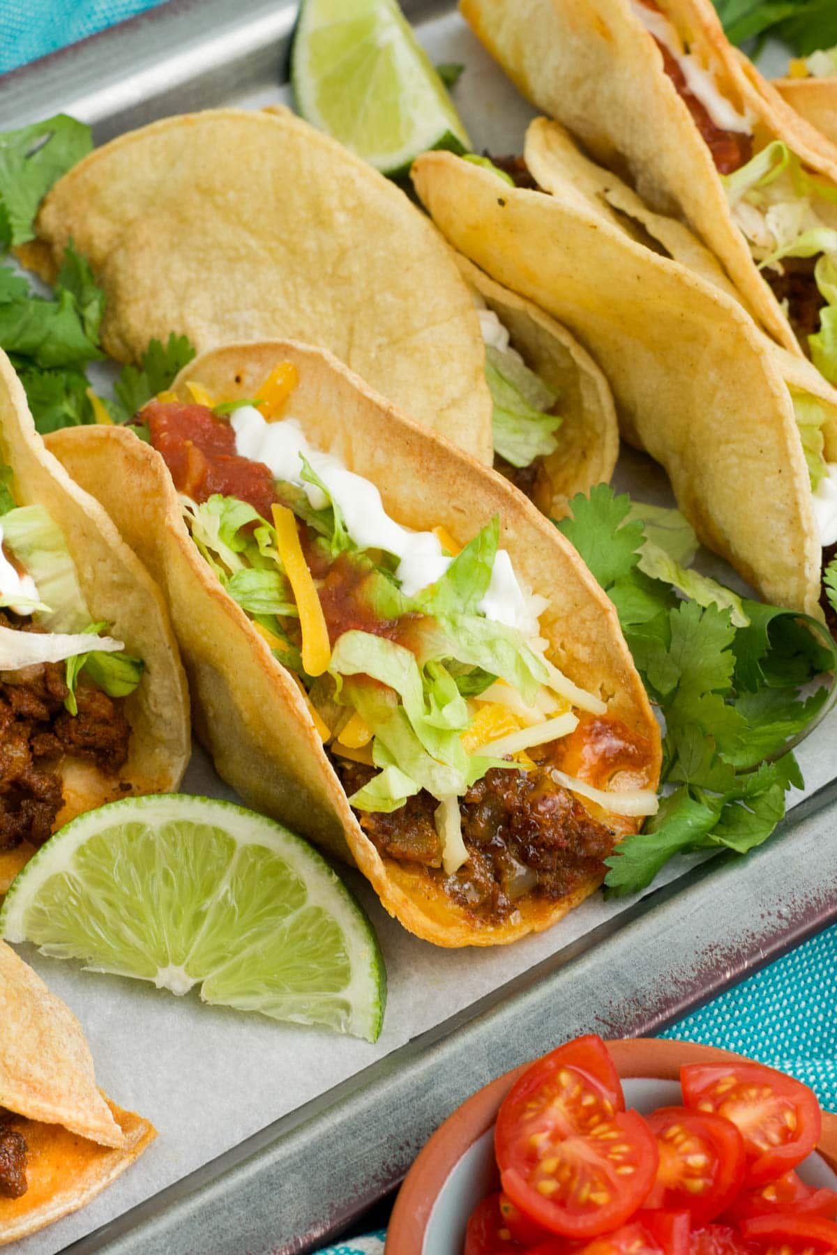 Crispy shell taco on a metal tray.