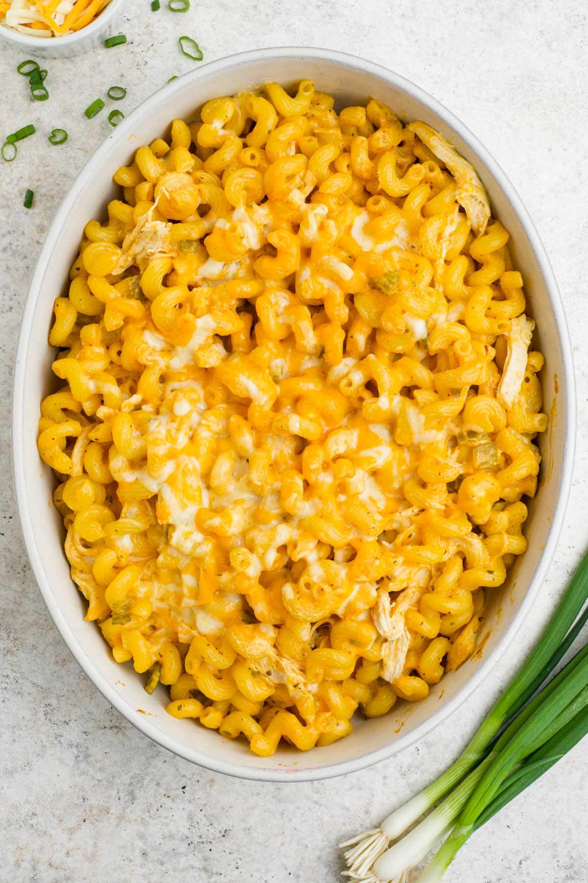 Baked buffalo chicken pasta in a white baking dish.