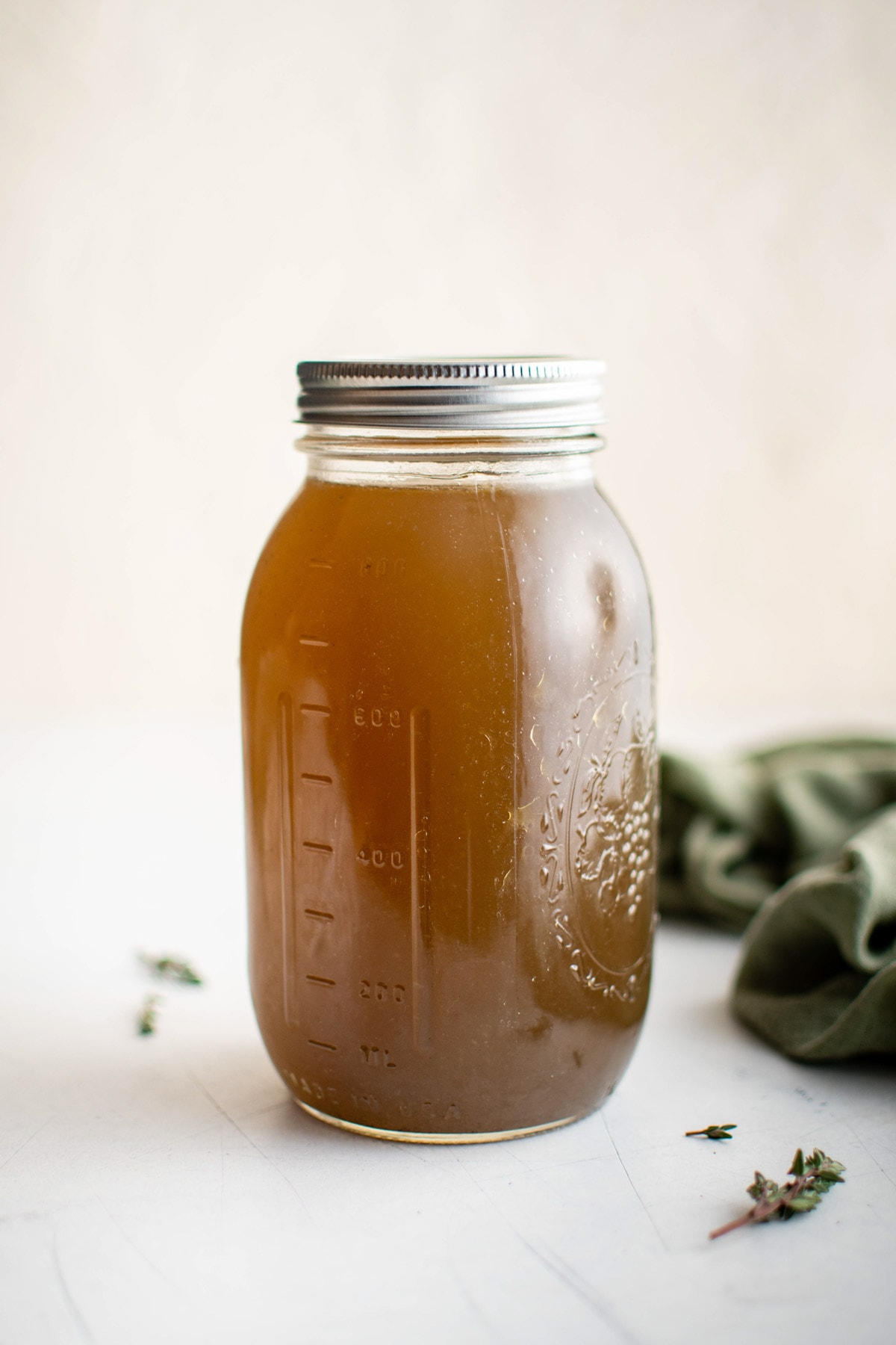 Homemade chicken broth in a sealed mason jar.