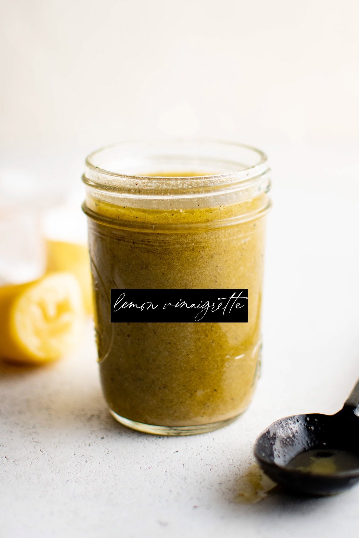 Glass mason jar with lemon vinaigrette.