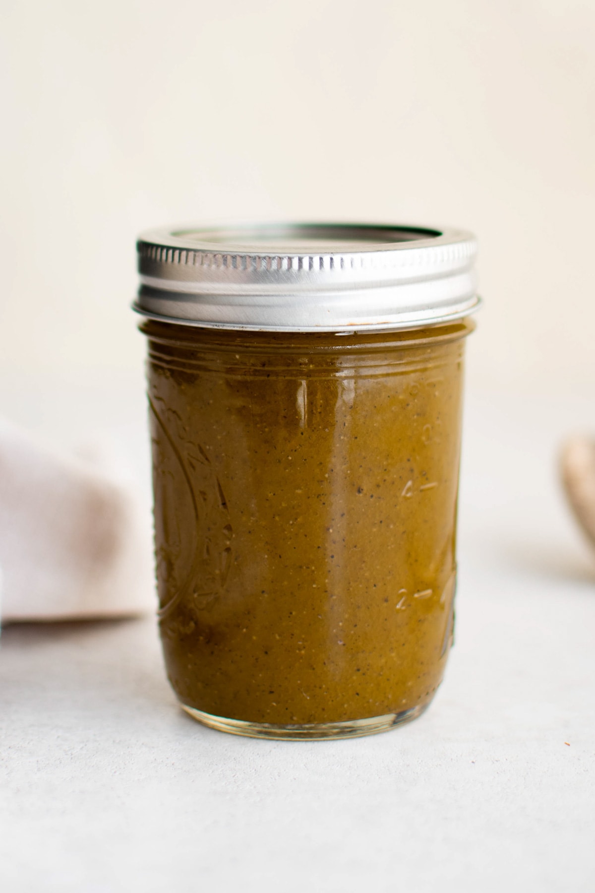 Oil and vinegar dressing in a sealed mason jar.