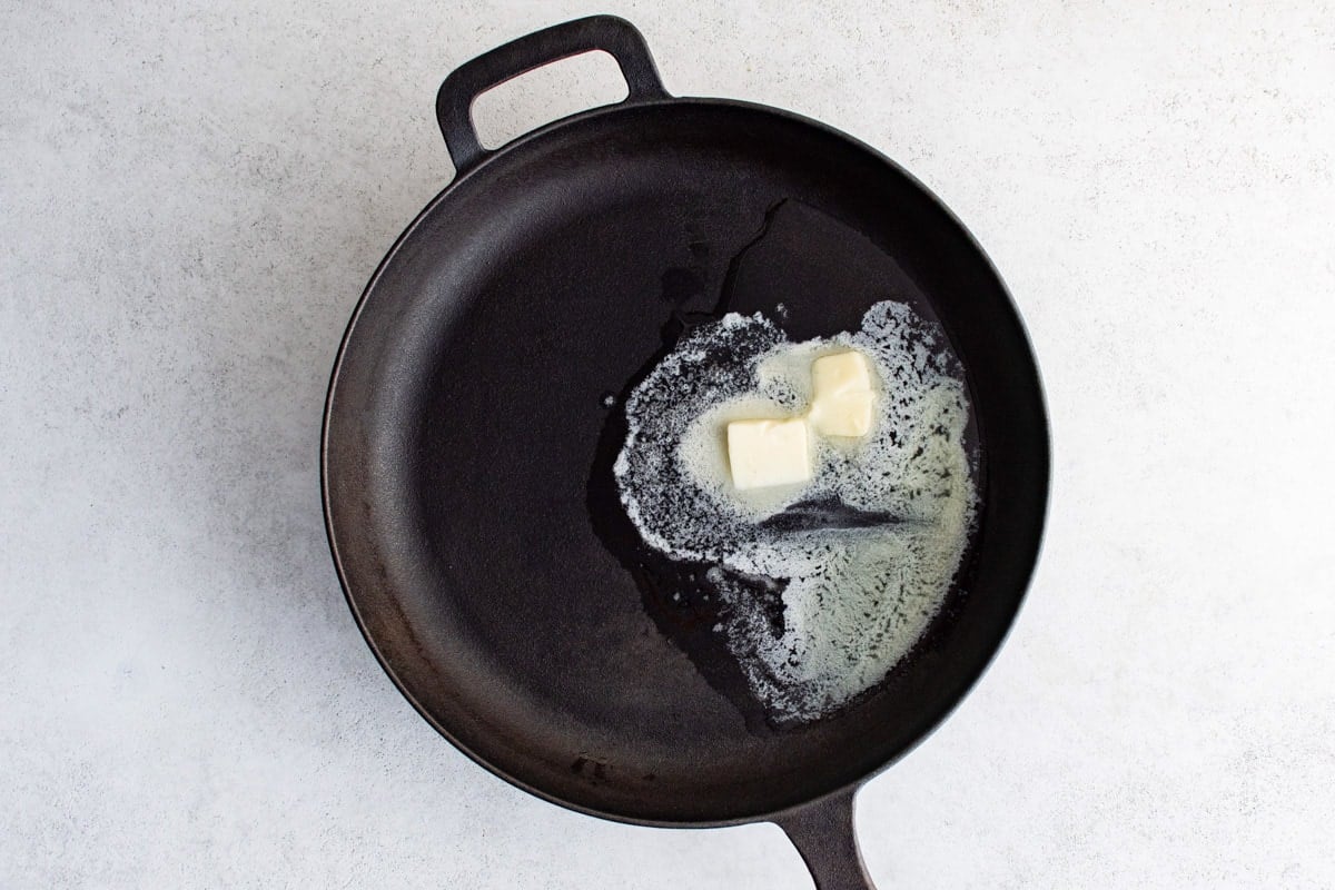 Melting butter in a cast iron skillet.